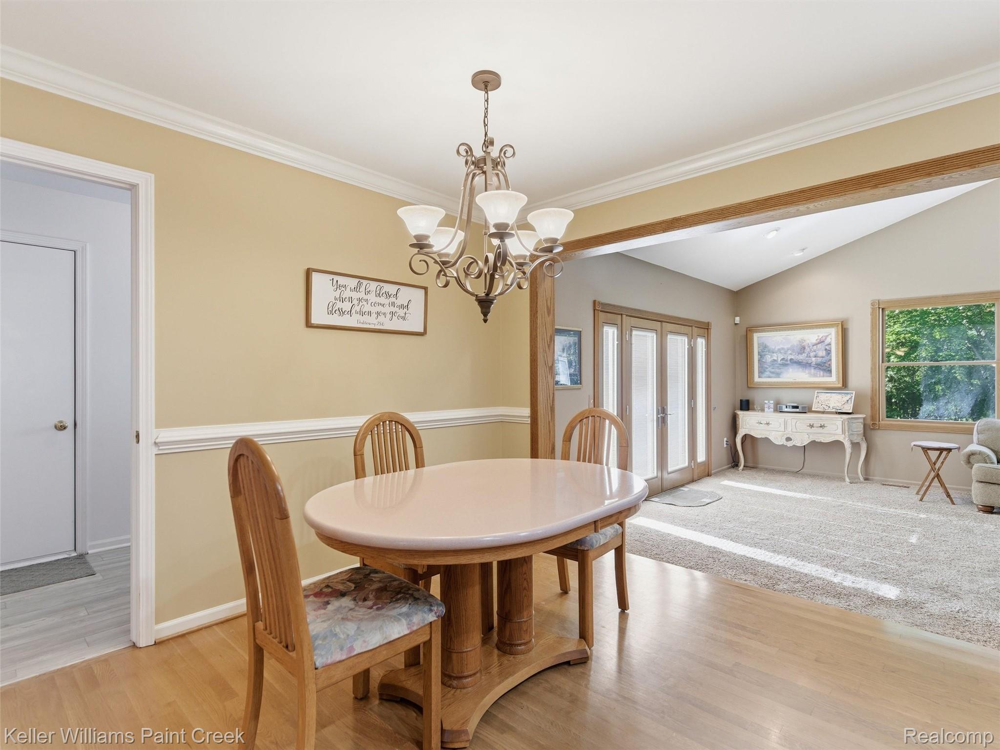 2842 Manorwood Road Troy, MI 48085 - Photo 40 of 72 Dining area featuring wood-finish flooring, a decorative chandelier, and crown molding