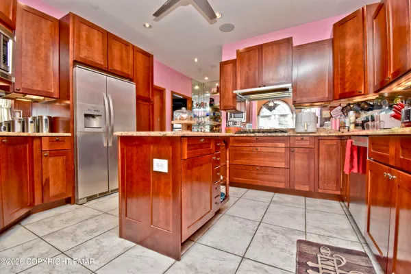 a kitchen with stainless steel appliances granite countertop wooden cabinets a sink and dishwasher