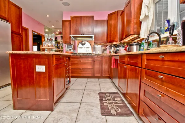 a kitchen with stainless steel appliances a sink stove and cabinets