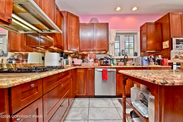 a kitchen with stainless steel appliances granite countertop a sink stove and cabinets