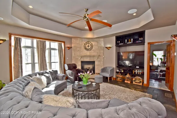 a living room with furniture and a fireplace