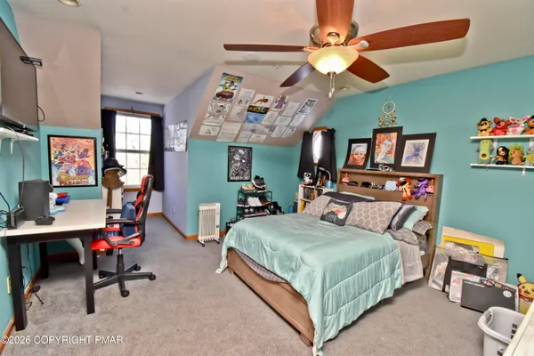 a bedroom with a bed a desk and chair