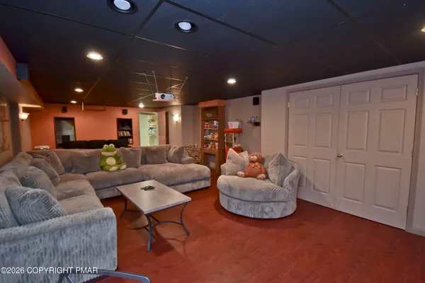 a living room with furniture and a wooden door