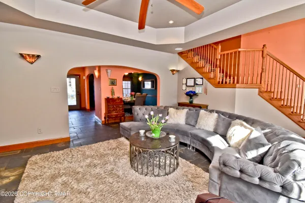 a living room with furniture and a wooden floor