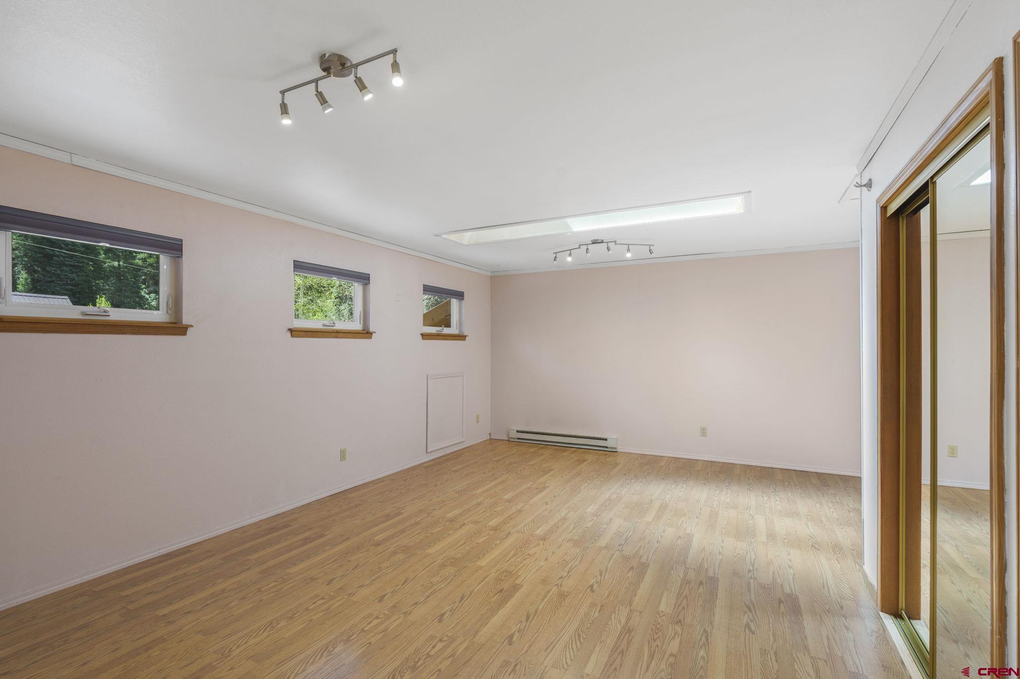 37 Verde Lane Durango, CO 81301 - Photo 25 of 45 a view of an empty room with wooden floor and a window