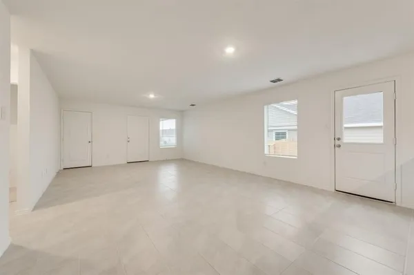 an empty room with windows and closet