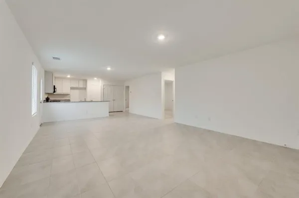 a view of a kitchen with a sink and a refrigerator