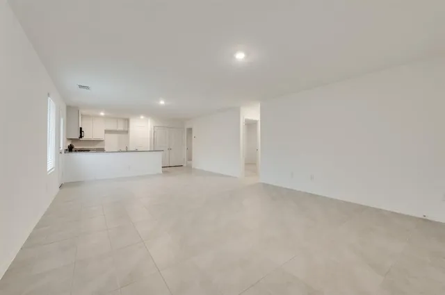 a view of a kitchen with a sink and a refrigerator