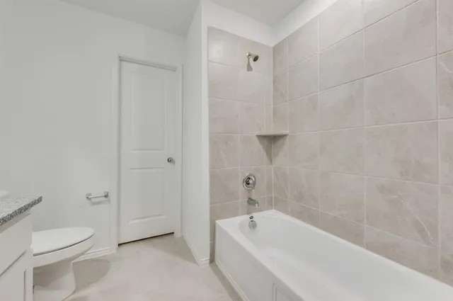 a bath room with a toilet sink and a bath tub