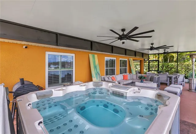 a dining room with furniture and a large window