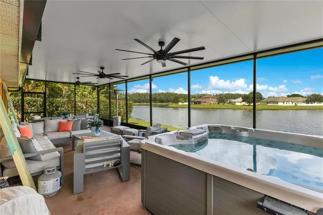 a living room with furniture and floor to ceiling window