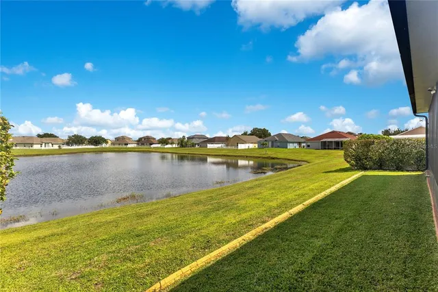 a view of a lake with houses in the back
