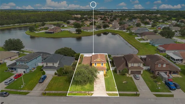 an aerial view of a house with a yard