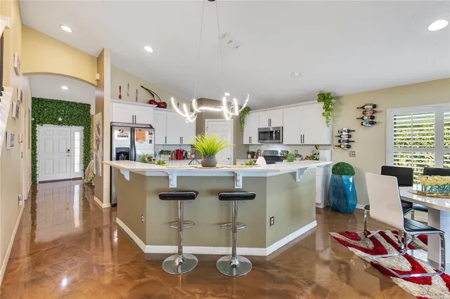 a kitchen that has a lot of cabinets in it and appliances