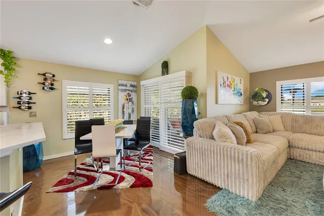 a living room with fireplace furniture and a large window
