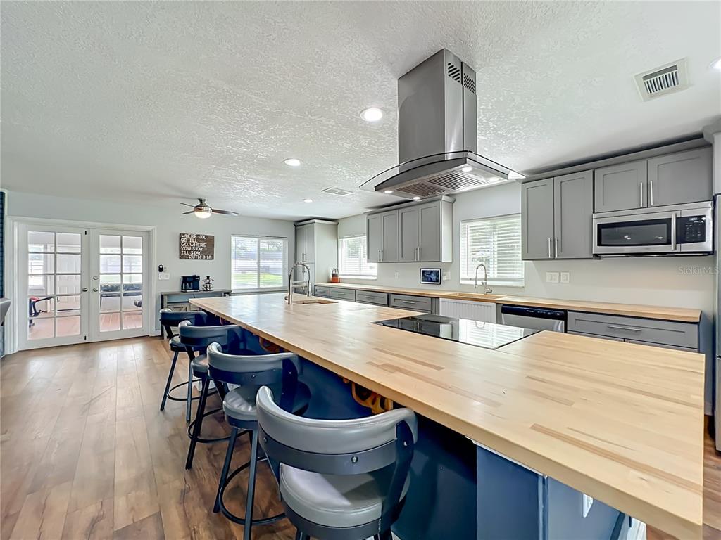 153 Variety Tree Circle Altamonte Springs, FL 32714 - Photo 8 of 44 a kitchen with a table chairs microwave and cabinets