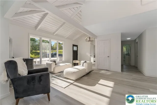 a living room with furniture and large windows