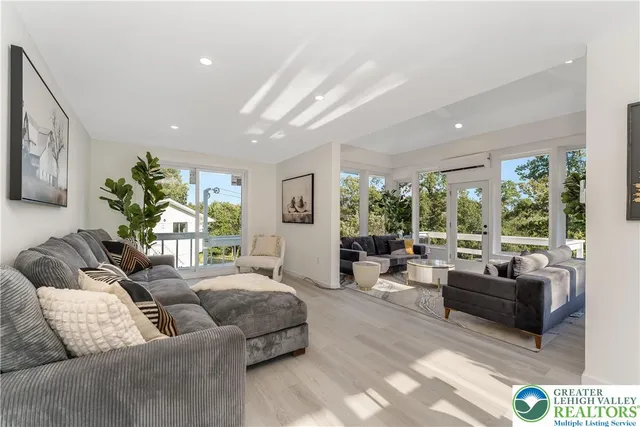 a living room with furniture and a large window