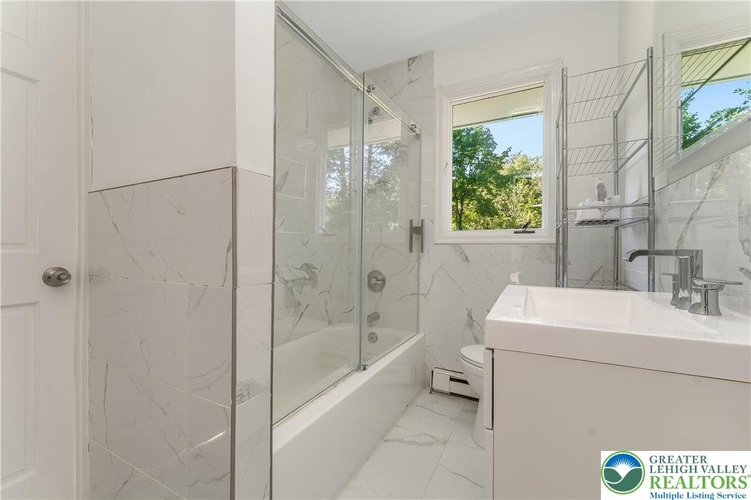 1855 Ridge Road Bangor, PA 18013 - Photo 19 of 53 a bathroom with a bathtub a shower a sink and a toilet