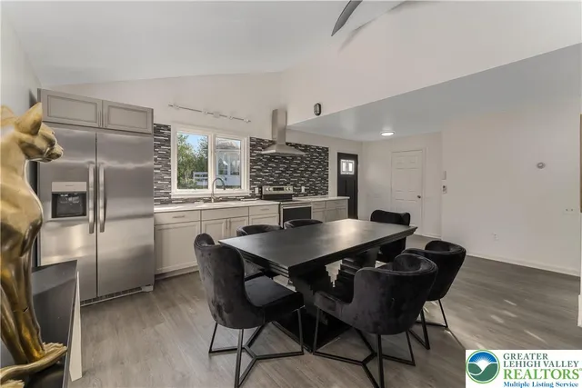 a view of a kitchen with a table and chairs