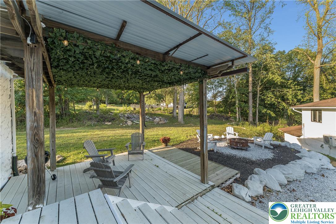 1855 Ridge Road Bangor, PA 18013 - Photo 31 of 53 a view of a patio with lawn chairs floor to ceiling window and wooden floor