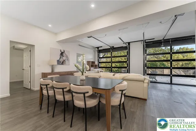 a dining room with furniture and wooden floor