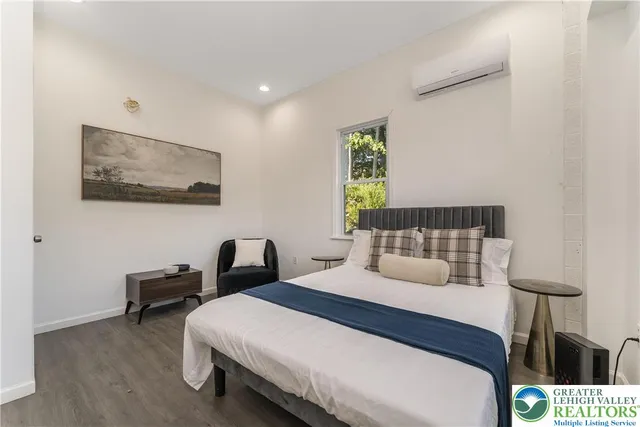 a bedroom with a bed and a table