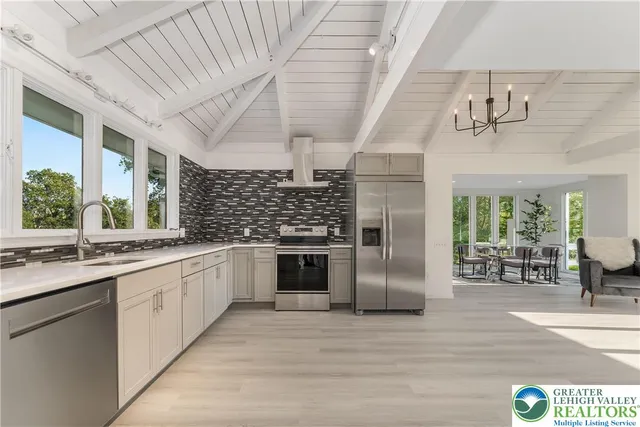 a kitchen with stainless steel appliances granite countertop a sink and cabinets