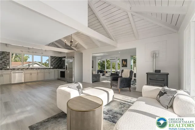 a living room with furniture and kitchen view