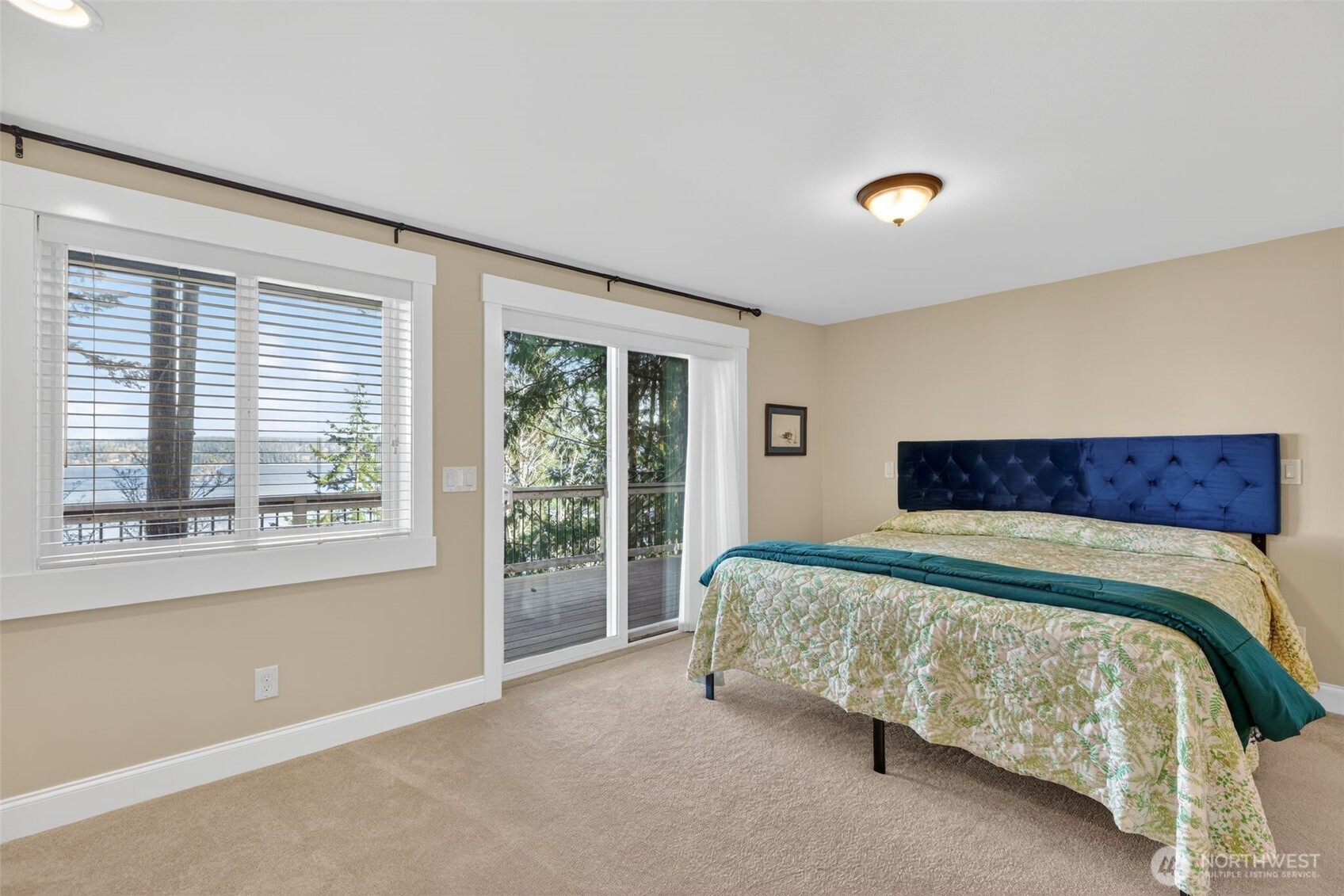 510 Carl Johnson Road Quilcene, WA 98376 - Photo 16 of 37 a spacious bedroom with a bed and a large window