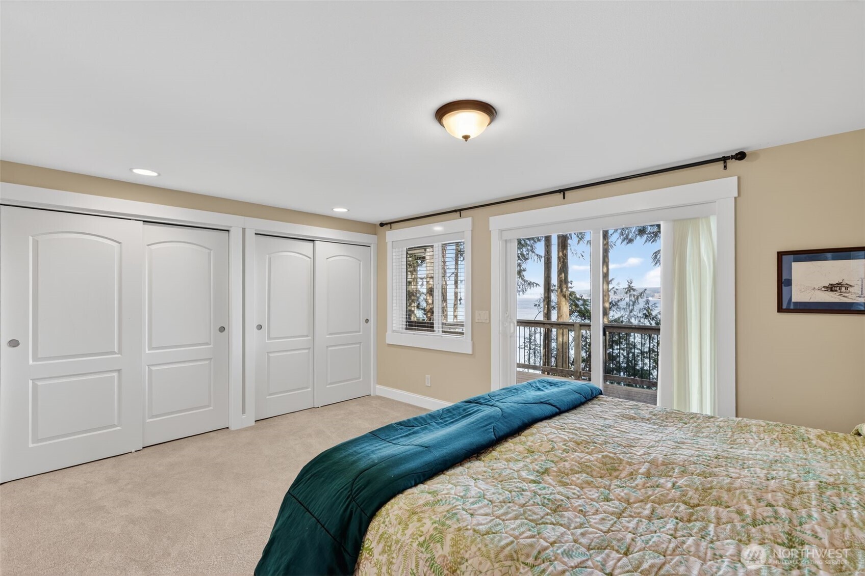 510 Carl Johnson Road Quilcene, WA 98376 - Photo 17 of 37 a bedroom with a large bed and a chandelier