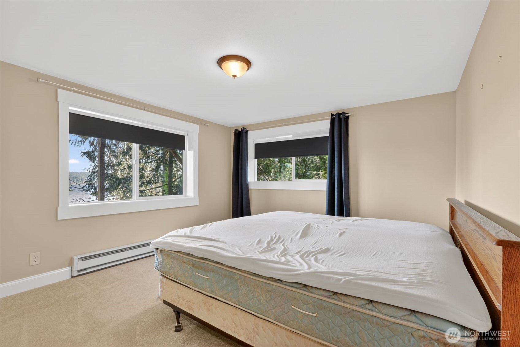 510 Carl Johnson Road Quilcene, WA 98376 - Photo 27 of 37 a bedroom with a bed and a window