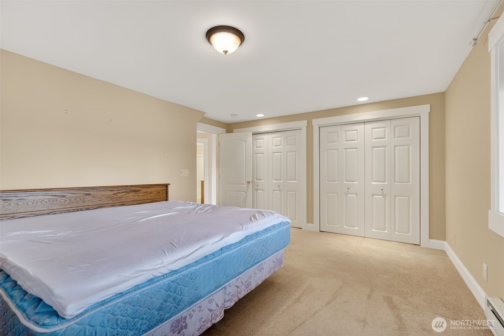 510 Carl Johnson Road Quilcene, WA 98376 - Photo 29 of 37 a spacious bedroom with a bed and a cabinets