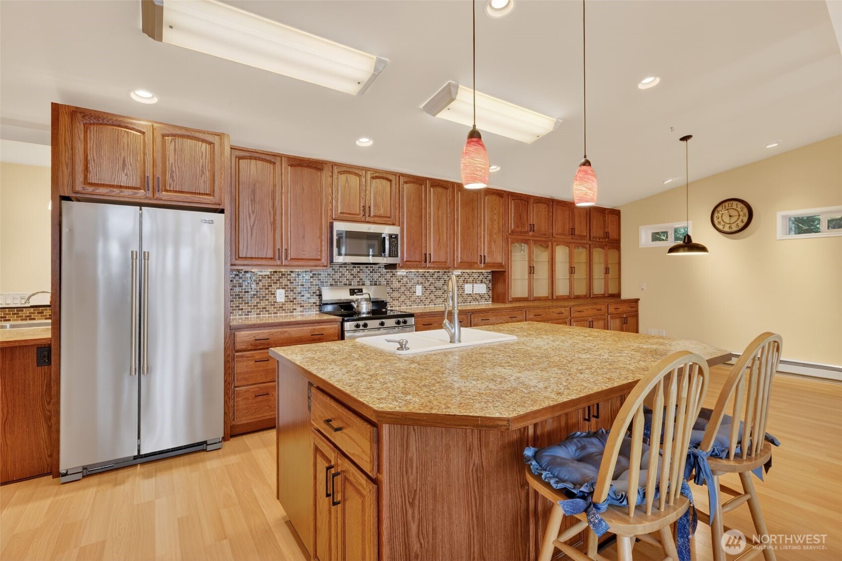 510 Carl Johnson Road Quilcene, WA 98376 - Photo 8 of 37 a kitchen with kitchen island a refrigerator stove microwave and cabinets