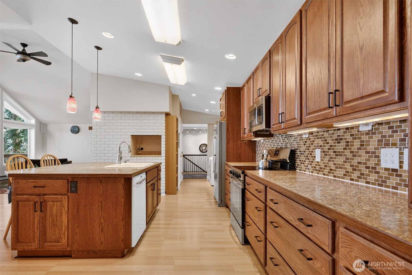 510 Carl Johnson Road Quilcene, WA 98376 - Photo 9 of 37 a kitchen with stainless steel appliances granite countertop a sink a stove and a wooden cabinets