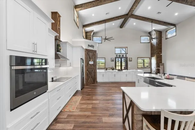 a kitchen with stainless steel appliances granite countertop a refrigerator and a stove