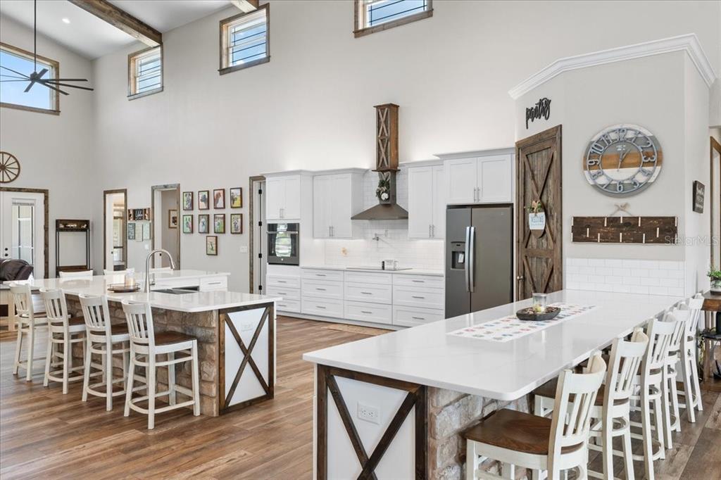 11657 Moore Road Lakeland, FL 33809 - Photo 16 of 100 a view of a dining room with furniture and wooden floor