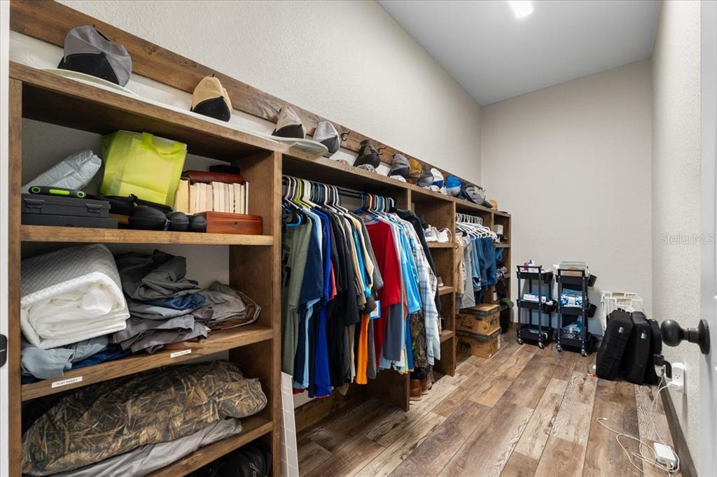 11657 Moore Road Lakeland, FL 33809 - Photo 28 of 100 a view of walk in closet with clothes and shoes