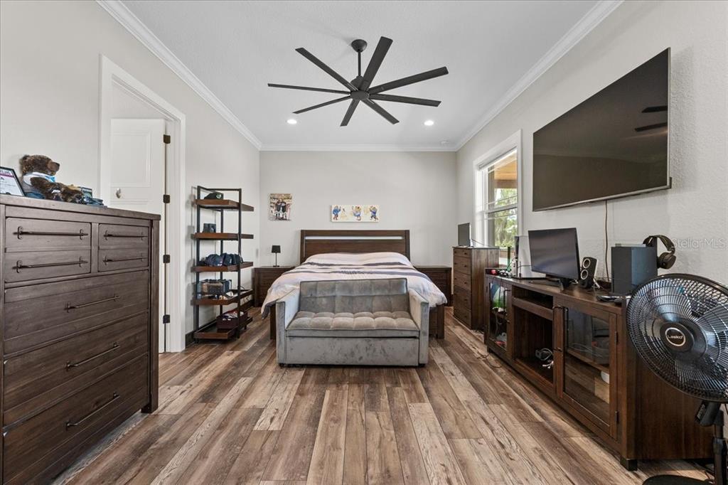 11657 Moore Road Lakeland, FL 33809 - Photo 29 of 100 a bedroom with a bed and a flat screen tv