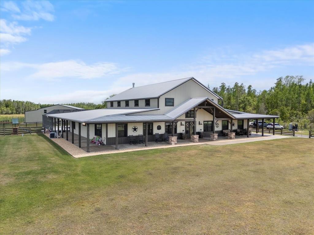 11657 Moore Road Lakeland, FL 33809 - Photo 3 of 100 a view of a house with a big yard and large trees