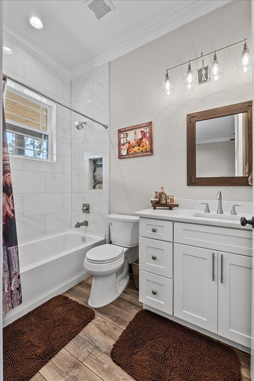 11657 Moore Road Lakeland, FL 33809 - Photo 33 of 100 a spacious bathroom with a toilet a sink a mirror a bathtub and vanity