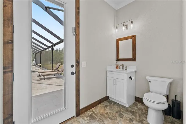 a living room with furniture and a kitchen view