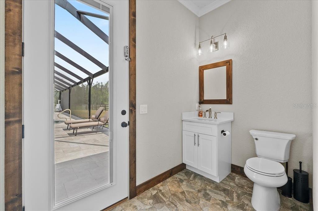 11657 Moore Road Lakeland, FL 33809 - Photo 40 of 100 a bathroom with a toilet sink and mirror