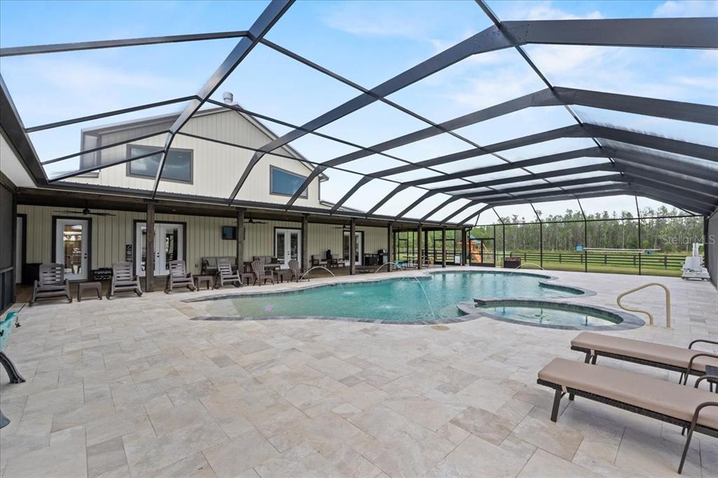11657 Moore Road Lakeland, FL 33809 - Photo 41 of 100 a view of a patio with a table and chairs under an umbrella