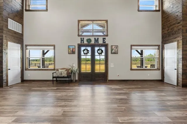 a living room with lots of furniture and kitchen view
