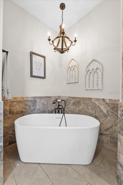 11657 Moore Road Lakeland, FL 33809 - Photo 59 of 100 a white bath tub sitting in a bathroom