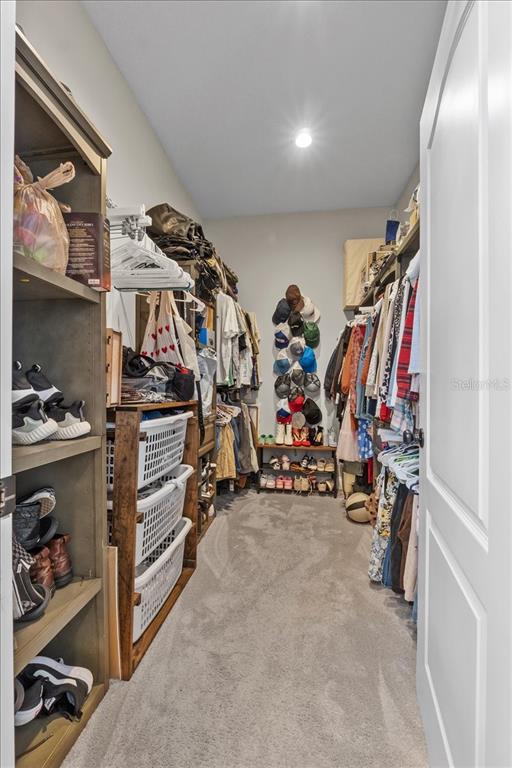 11657 Moore Road Lakeland, FL 33809 - Photo 62 of 100 a view of walk in closet with clothes and shoes