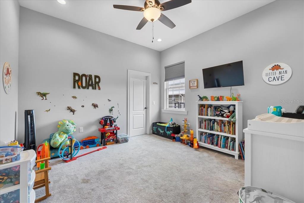 11657 Moore Road Lakeland, FL 33809 - Photo 65 of 100 a children room with toys and a flat screen tv