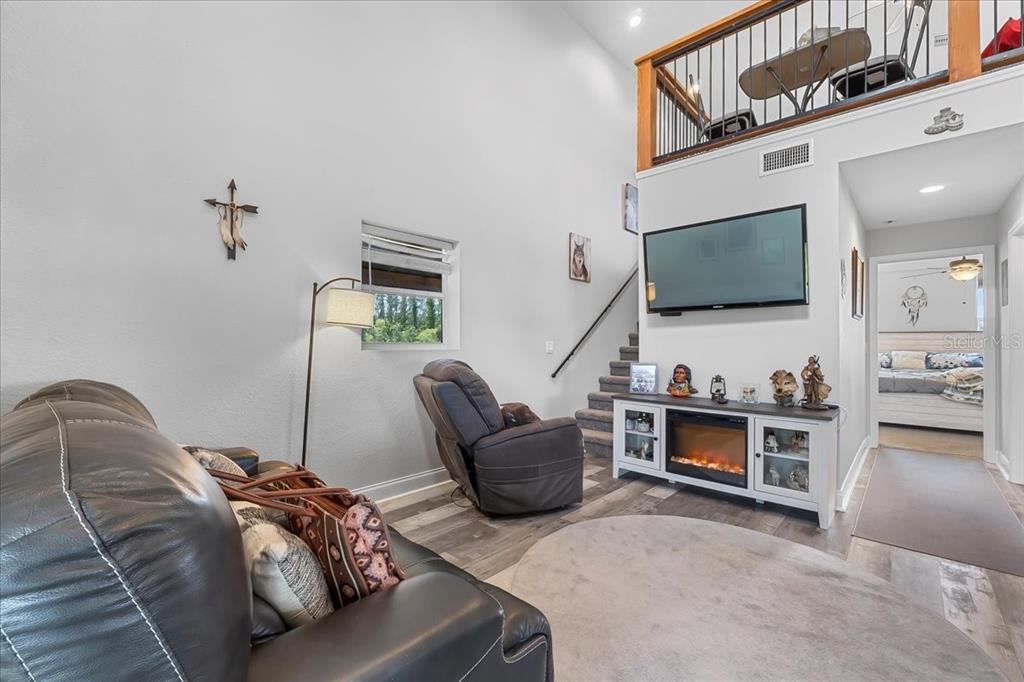 11657 Moore Road Lakeland, FL 33809 - Photo 73 of 100 a living room with furniture and a flat screen tv