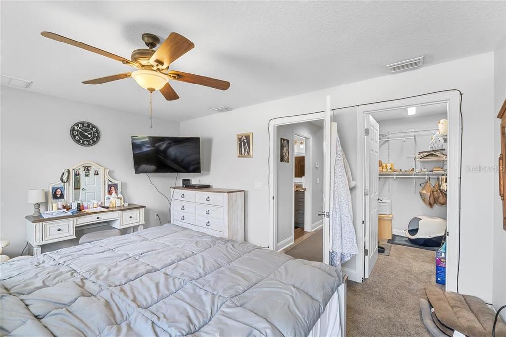 11657 Moore Road Lakeland, FL 33809 - Photo 76 of 100 a bedroom with a bed and a flat screen tv